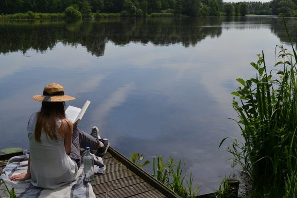 woman reading by lake