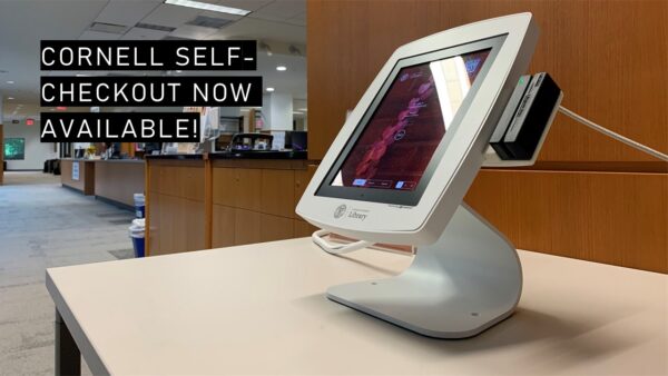 Photograph of self-checkout kiosk, with text: Cornell self-checkout now available!