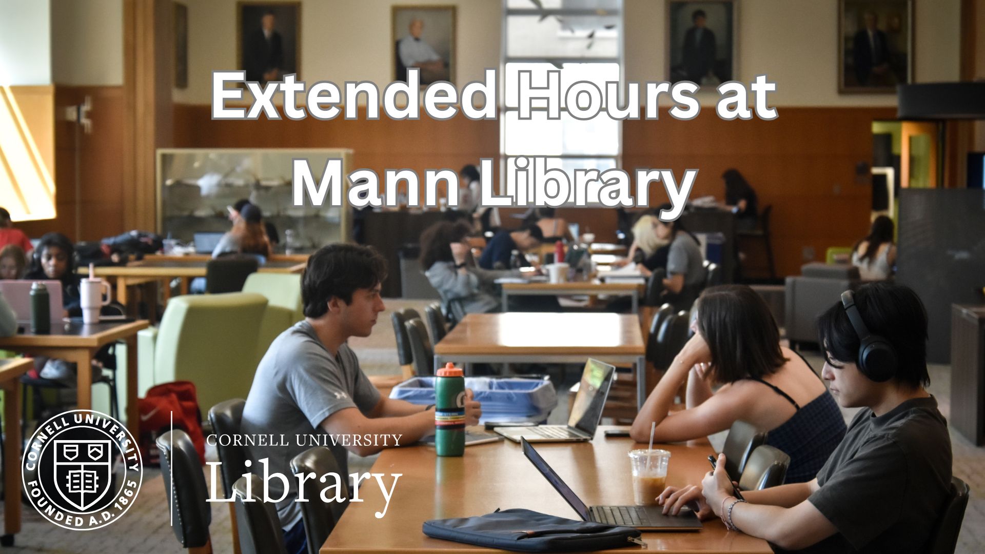 Students study at tables inside Mann Library, with laptops and books spread across a large reading room. Overlaid text reads “Extended Hours at Mann Library,” alongside the Cornell University Library logo.
